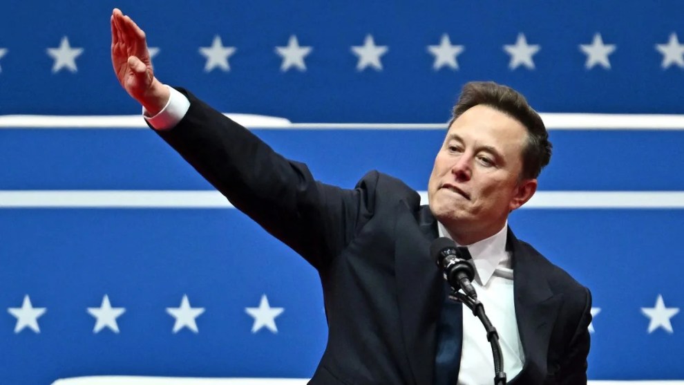 Elon Musk salutes as he speaks during the inaugural parade inside Capitol One Arena, in Washington, DC, on January 20, 2025. (Photo by ANGELA WEISS / AFP) (Photo by ANGELA WEISS/AFP via Getty Images)